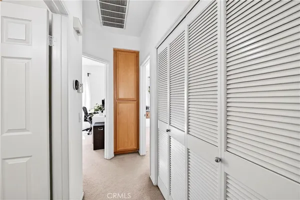 a view of a hallway with bathroom