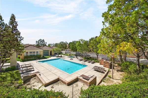 aerial view of a house with swimming pool and furniture