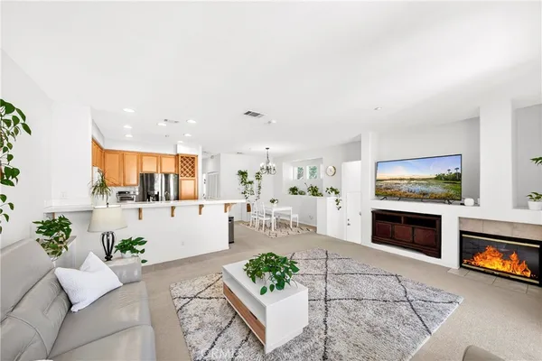 a living room with furniture a fireplace and a flat screen tv