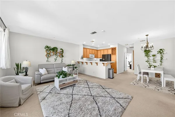 a living room with furniture and view of kitchen