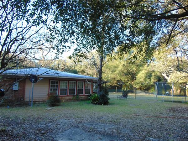 530 Harbuck Road DeFuniak Springs, FL 32433 - Photo 21 of 32 a view of a yard in front of a house with large trees