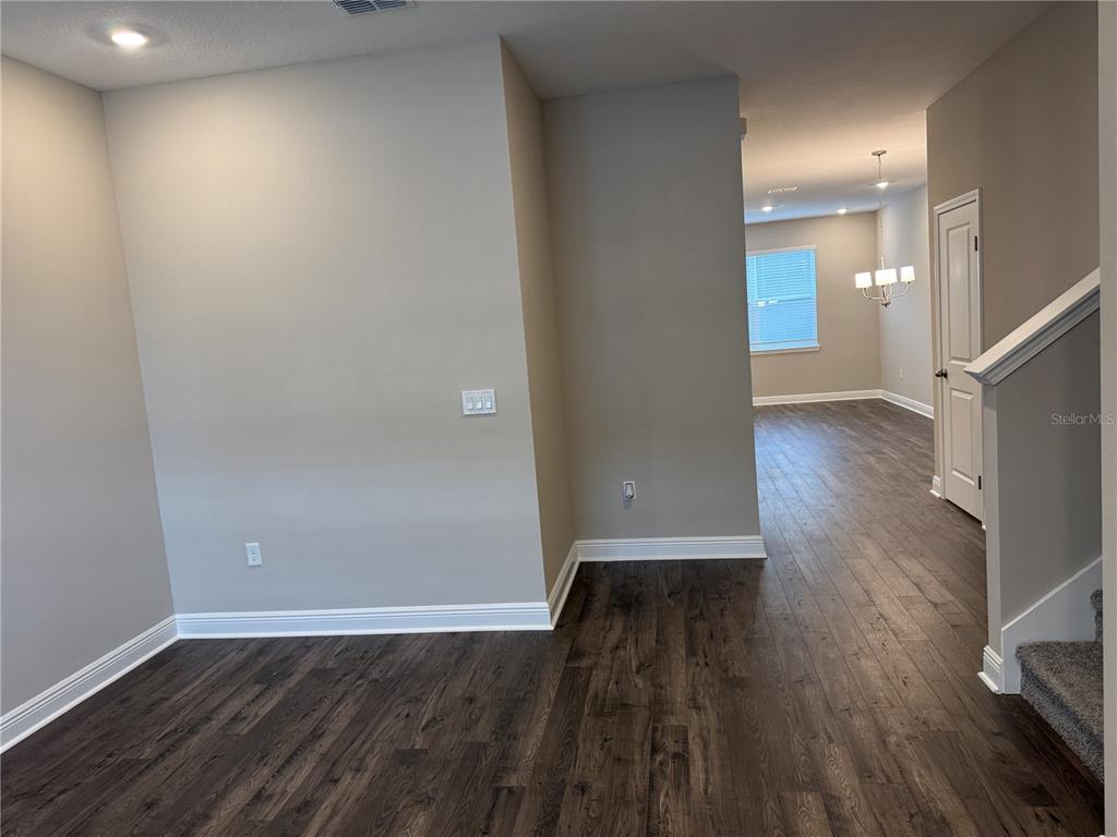 16434 Hamlin Hills Road Winter Garden, FL 34787 - Photo 6 of 50 a view of a hallway with wooden floor
