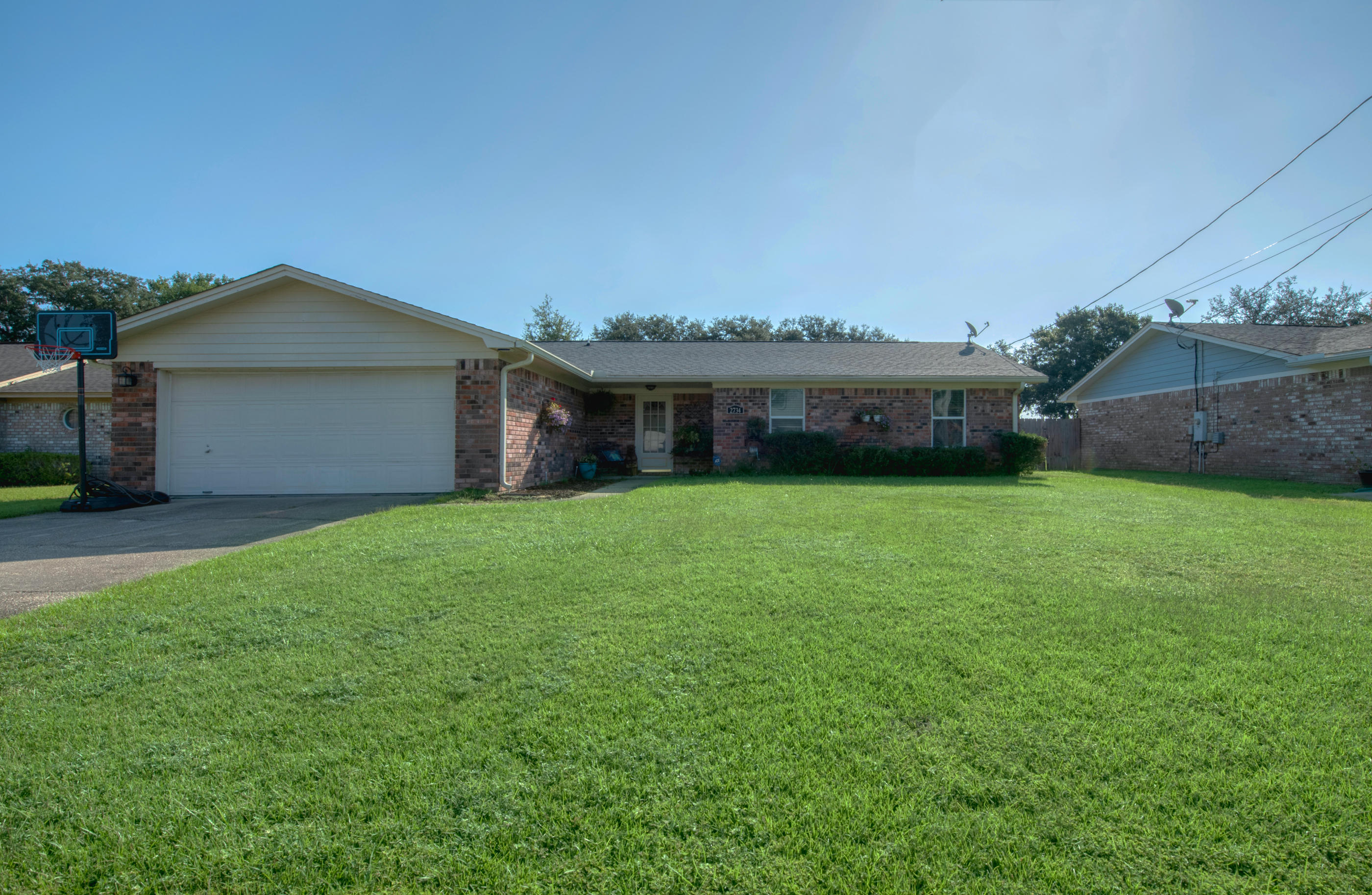 a view of house with yard and outdoor seating
