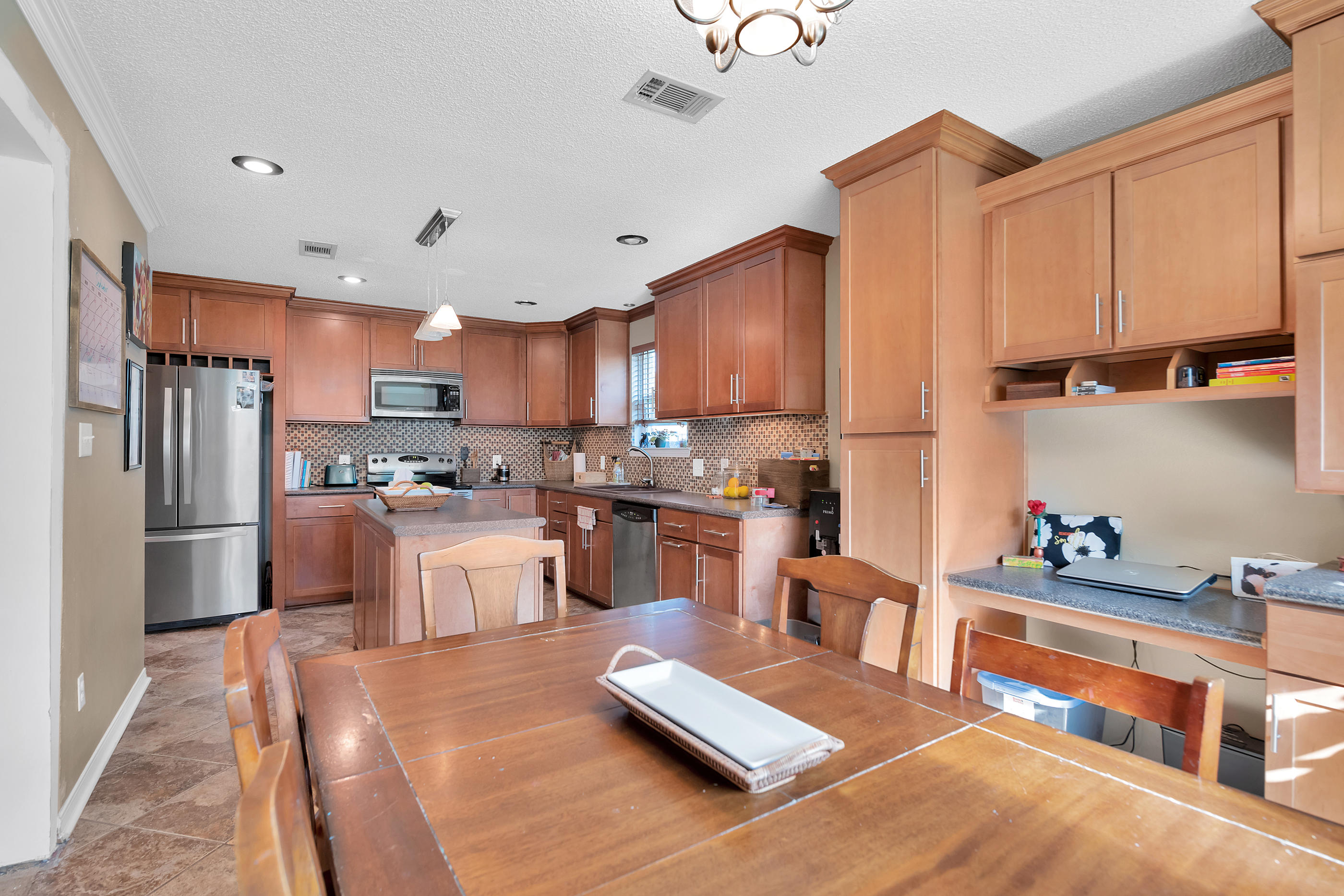 2734 Augustus Road Navarre, FL 32566 - Photo 12 of 23 a kitchen with stainless steel appliances granite countertop a refrigerator stove top oven a sink and dishwasher