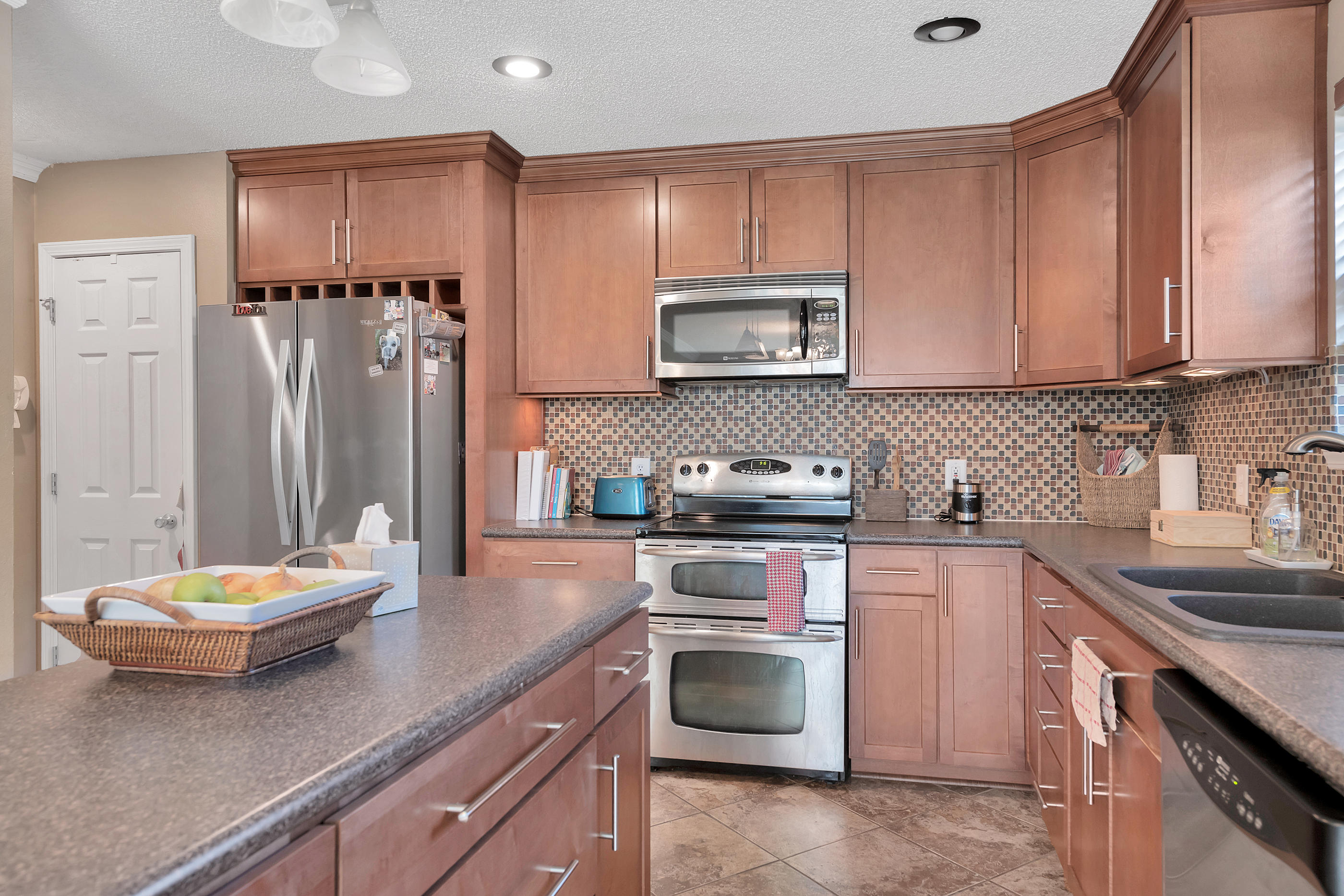 2734 Augustus Road Navarre, FL 32566 - Photo 14 of 23 a kitchen with a sink stove and microwave