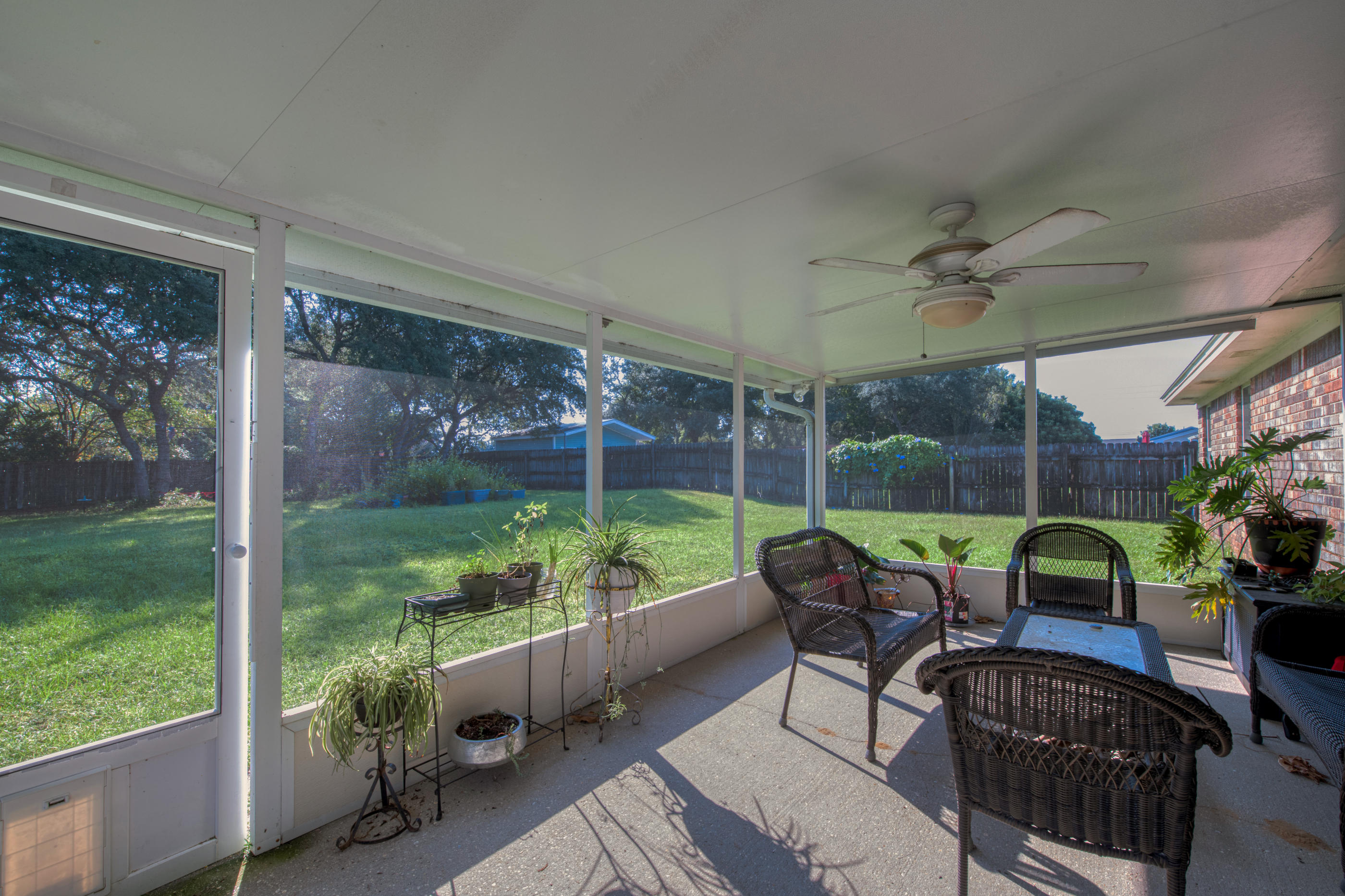 2734 Augustus Road Navarre, FL 32566 - Photo 19 of 23 a building outdoor space with patio furniture and garden