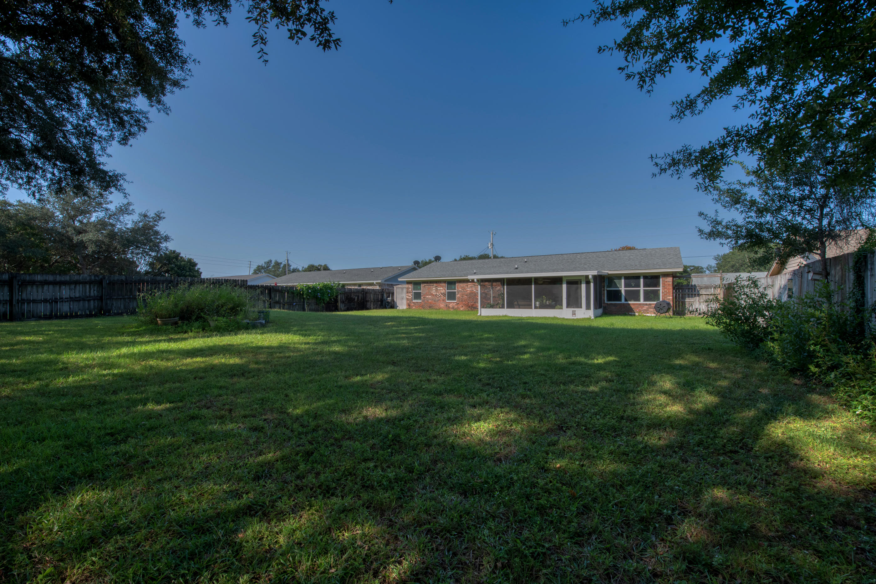 2734 Augustus Road Navarre, FL 32566 - Photo 21 of 23 a front view of a house with a yard