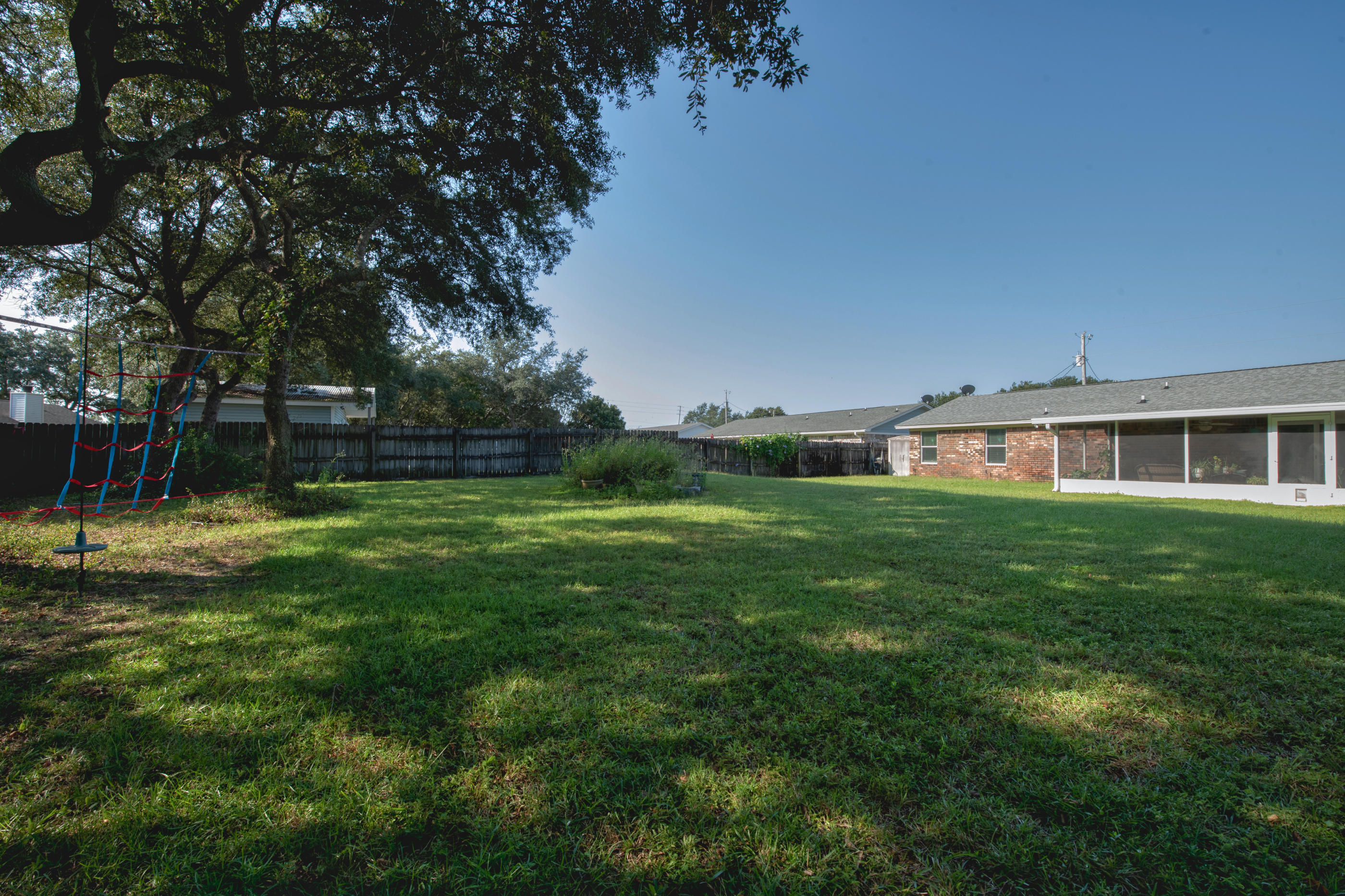 2734 Augustus Road Navarre, FL 32566 - Photo 22 of 23 a view of a house with a backyard