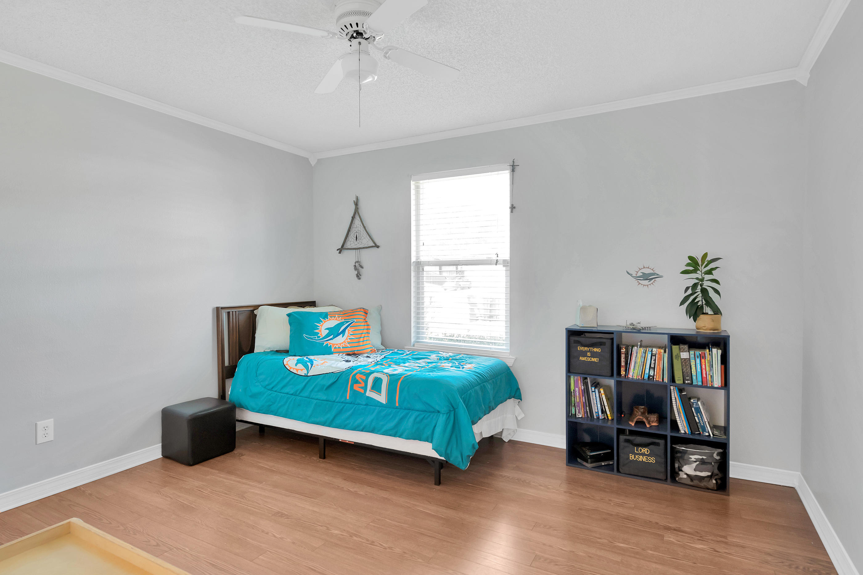 2734 Augustus Road Navarre, FL 32566 - Photo 4 of 23 a bedroom with a bed and a book shelf