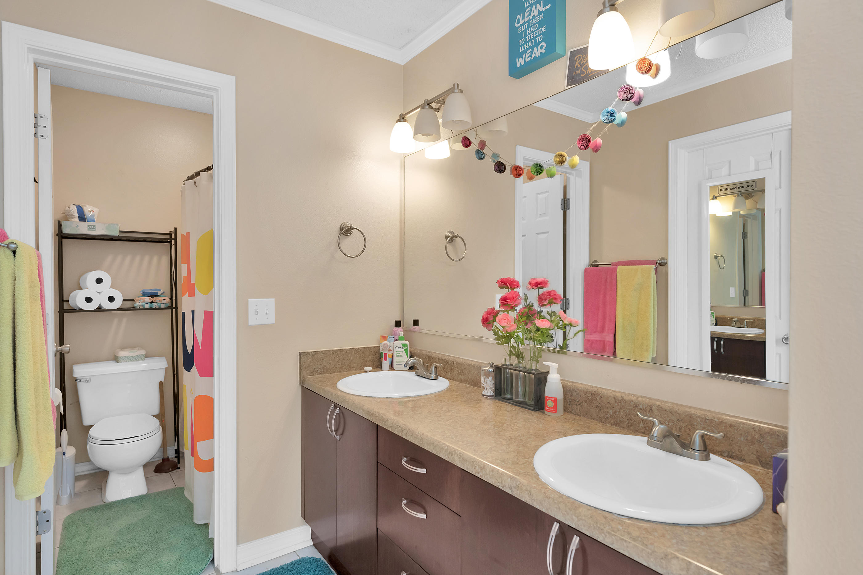 2734 Augustus Road Navarre, FL 32566 - Photo 7 of 23 a bathroom with a sink vanity mirror and toilet