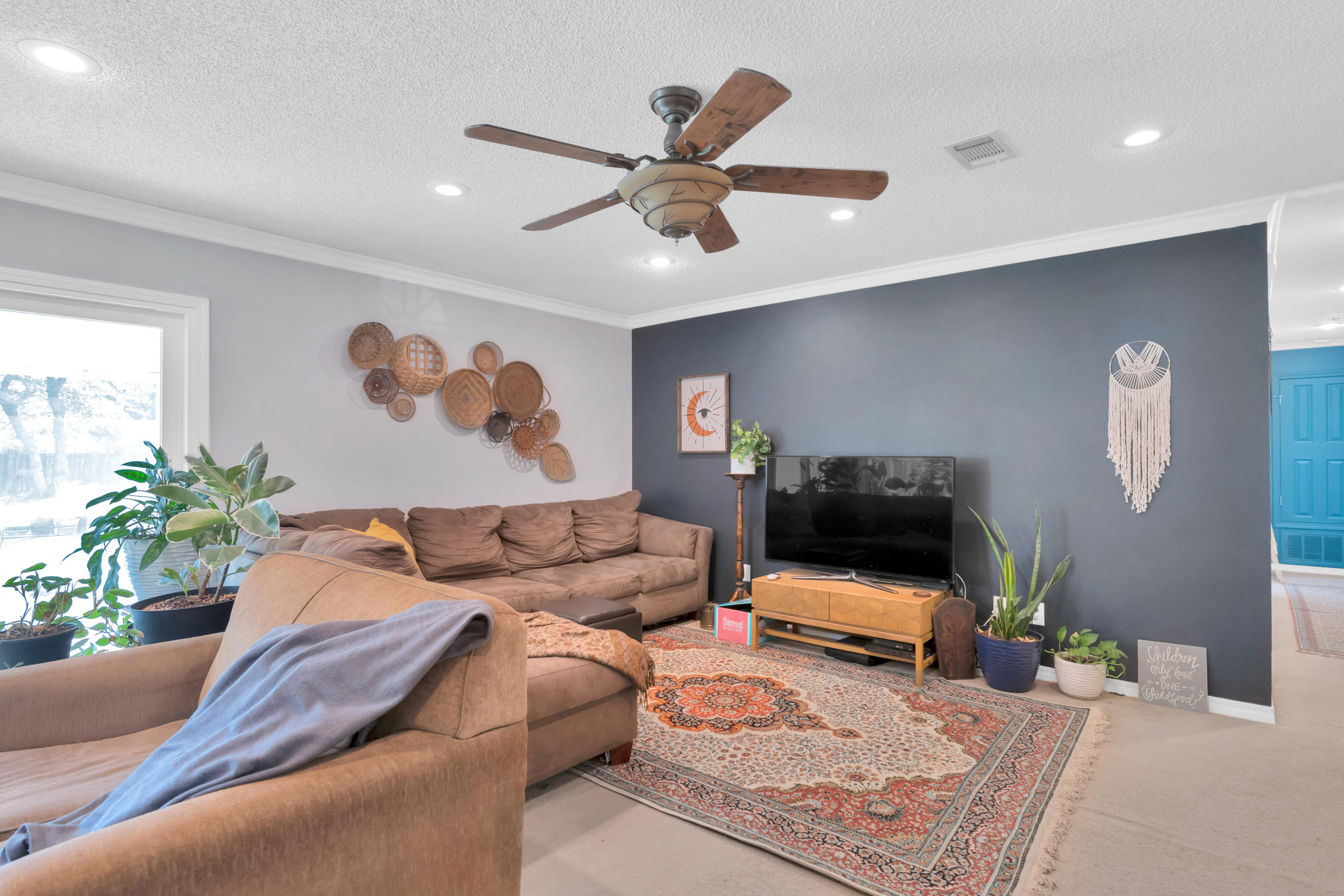 2734 Augustus Road Navarre, FL 32566 - Photo 10 of 23 a living room with furniture and a flat screen tv