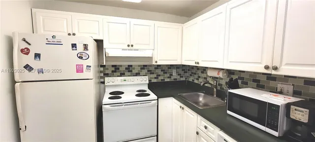 a kitchen with a refrigerator and a stove