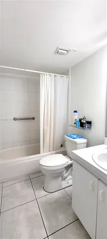 a bathroom with a sink a toilet and bathtub