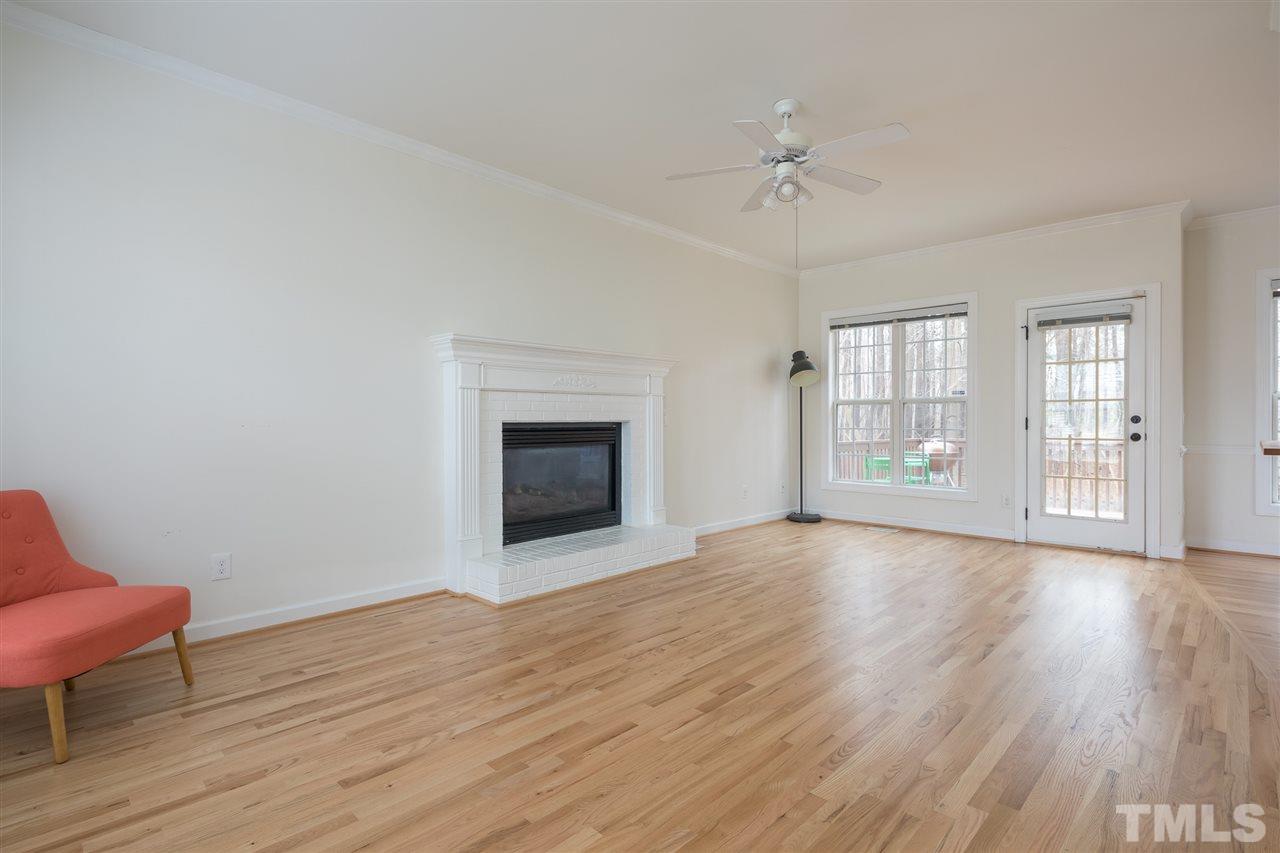 801 Shady Maple Court Raleigh, NC 27607 - Photo 5 of 22 a view of an empty room with a window and wooden floor