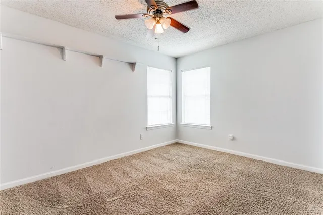 a view of room with window and ceiling fan