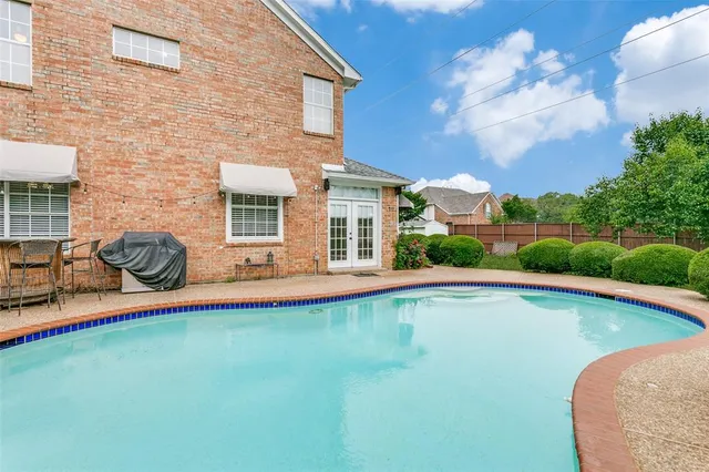 a view of a house with swimming pool and sitting area