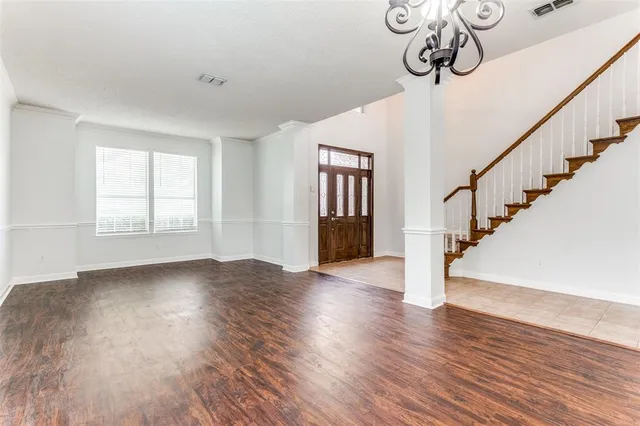 a view of an entryway with wooden floor and stairs