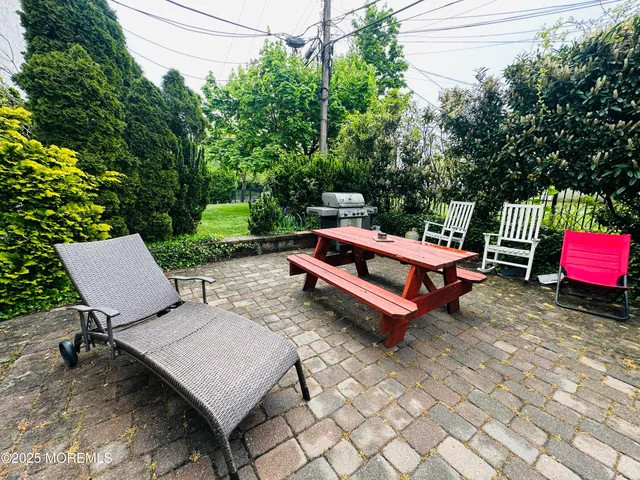 a backyard view with a sitting space