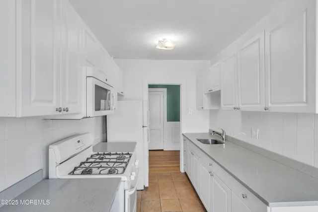 a kitchen with cabinets and appliances