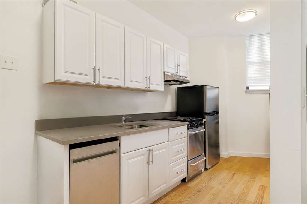 a kitchen with cabinets appliances and a sink