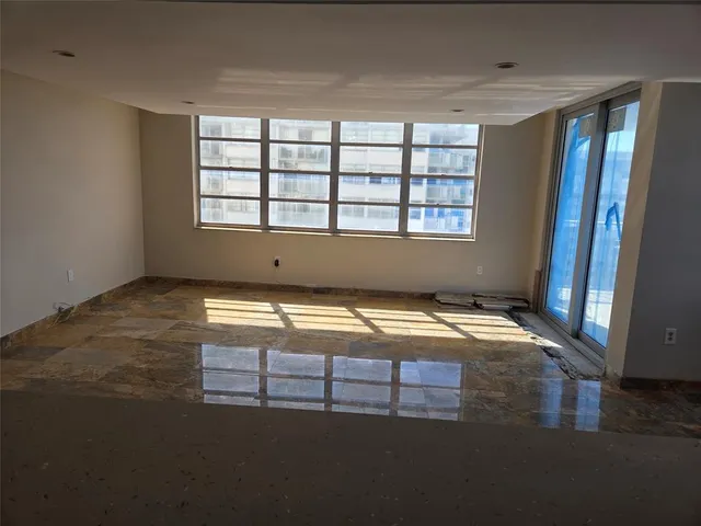 a kitchen with kitchen island a counter top space wooden floor and stainless steel appliances