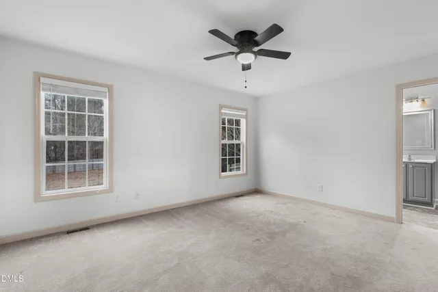 an empty room with a empty space and windows