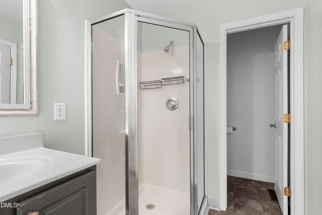a bathroom with a shower and a sink