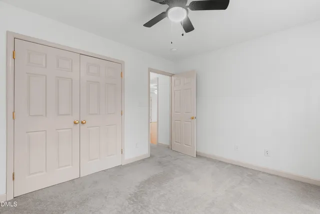 an empty room with a ceiling fan