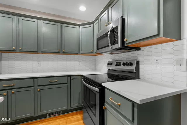 a kitchen with a cabinets and a stove top oven
