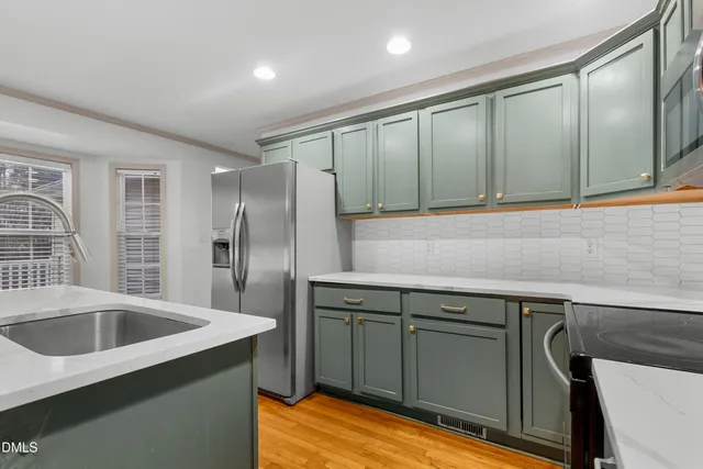 a kitchen with a sink and refrigerator