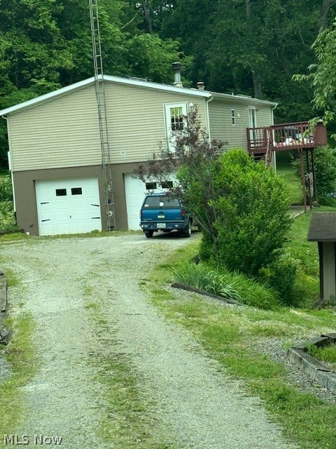 4000 Tabor Ridge Road Northeast Mineral City, OH 44656 - Photo 2 of 4 View of front of home with driveway, an attached garage, and a deck