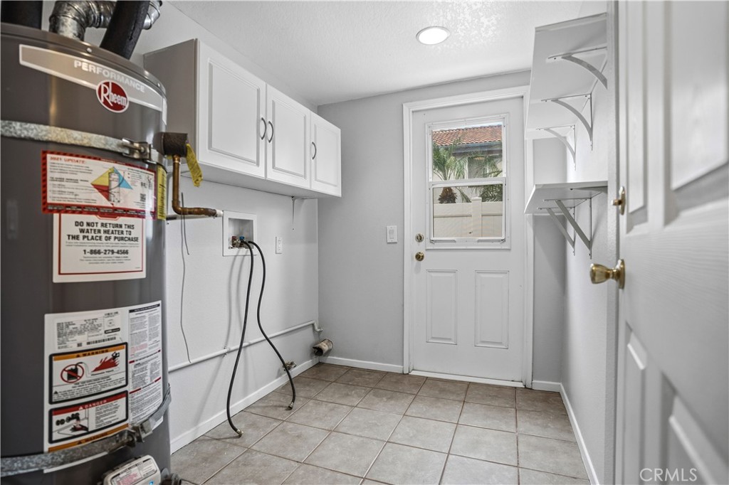 6568 Balzac Circle Riverside, CA 92506 - Photo 15 of 62 Laundry room was converted from the garage area to it's own seperate indoor room. Tons of cupboards and a door to the back yard.Recessed lighting above. Double strapped water heater here. Door outside leads to the side yard. New goodman 5 ton ac was recently added.