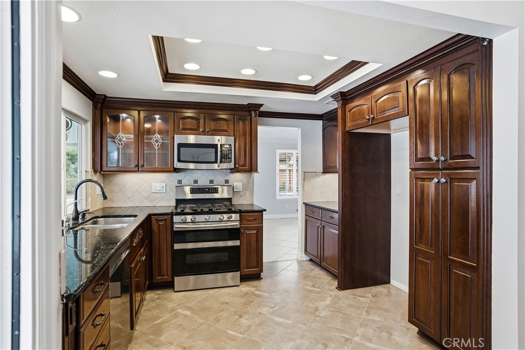 6568 Balzac Circle Riverside, CA 92506 - Photo 23 of 62 Kitchen was designed for massive cupboard space and functionality. Doorway to the formal dining room/living room space.