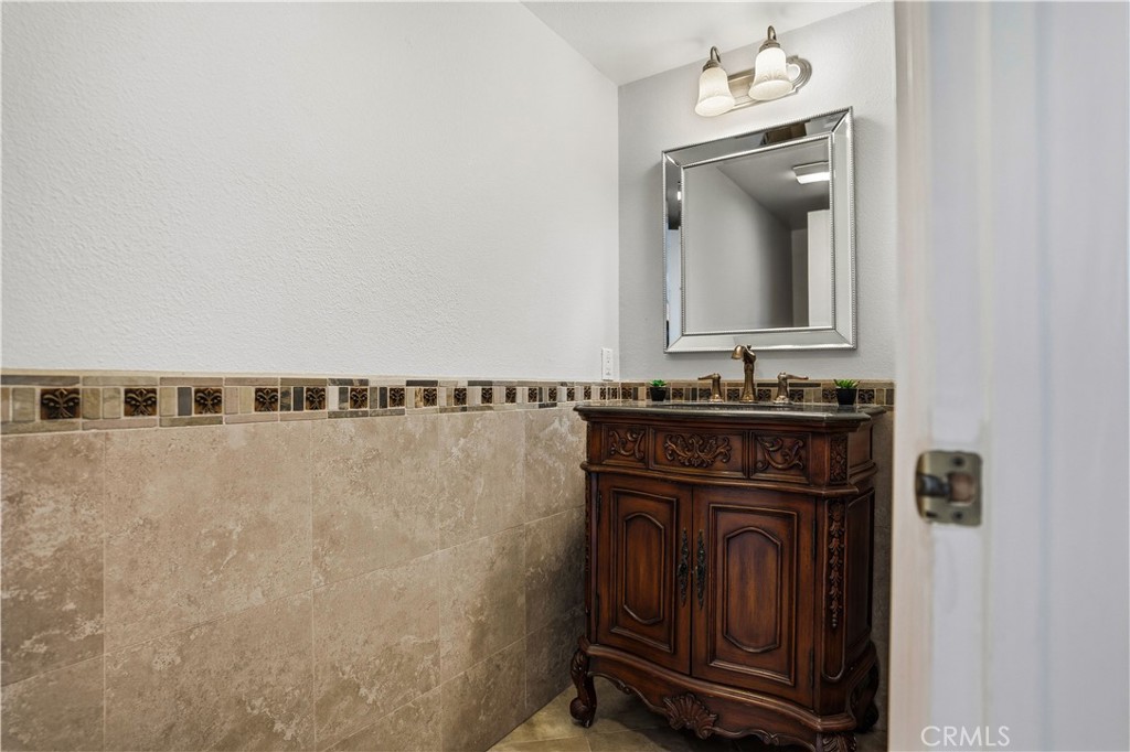 6568 Balzac Circle Riverside, CA 92506 - Photo 26 of 62 Downstairs bathroom with custom wood vanity to match the kitchen is in the hallway.