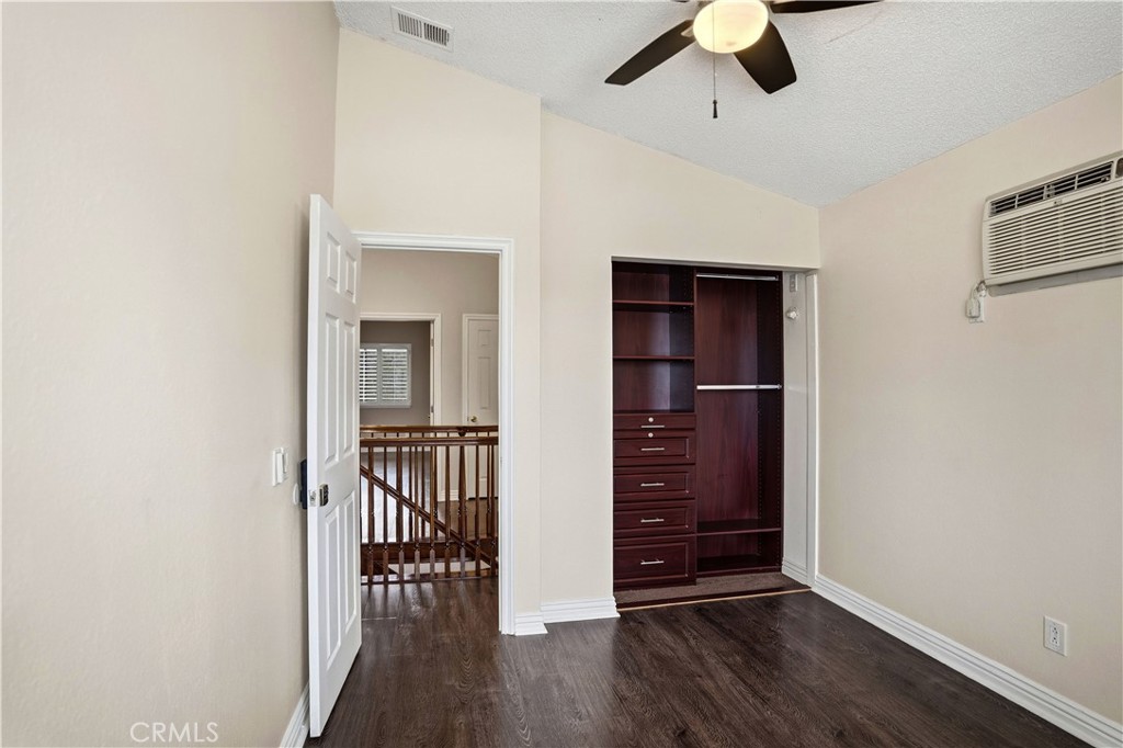 6568 Balzac Circle Riverside, CA 92506 - Photo 30 of 62 Upstirs bedroom has mini-split ac for instant air conditioning as well as the central air! Wood laminate flooring. Custom closet world closet built-in. Ceiling fan above.