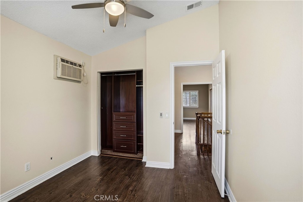 6568 Balzac Circle Riverside, CA 92506 - Photo 32 of 62 Anothe bedroom upstairs has mini split air conditionar for instant cold air. Central ac also here. Custom built closet world closet. Wood laminate flooring.