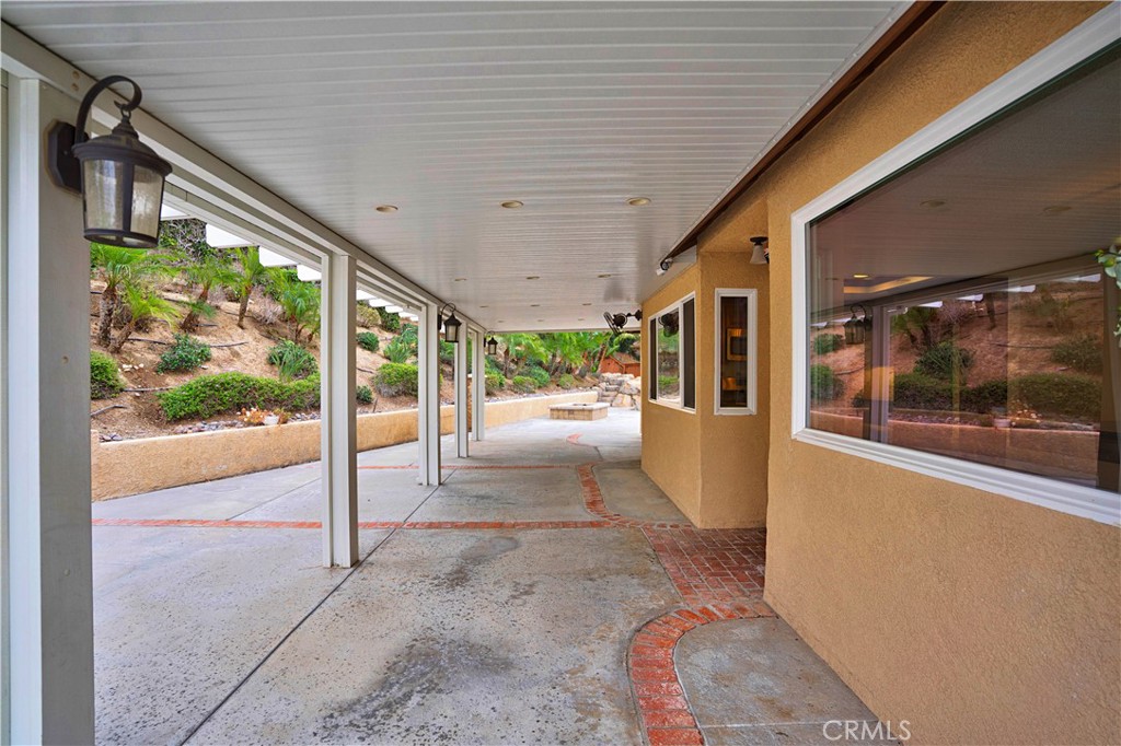 6568 Balzac Circle Riverside, CA 92506 - Photo 40 of 62 Alumawood patio runs the lenght of the kitchen area for massive outdoor entertaining. Custtom lights and recessed lighting in patio. COncrete stamped makes it easy to clean.Firepit and salt water pool grotto in the far corner.