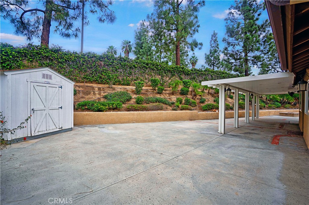 6568 Balzac Circle Riverside, CA 92506 - Photo 43 of 62 Stamped concrete back yard patio area with shed, and alumawood patio. Slope is landscaped on drip timer.