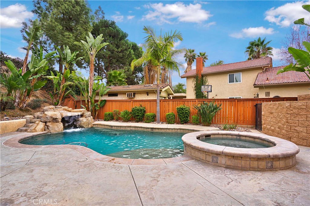 6568 Balzac Circle Riverside, CA 92506 - Photo 47 of 62 Salt-water pool and jacuzzi. The rock formation groot has a bnech inside underneath to sit and watch the waterfall. Shelf with hole for umbrella to just sit and relax on a hot day.