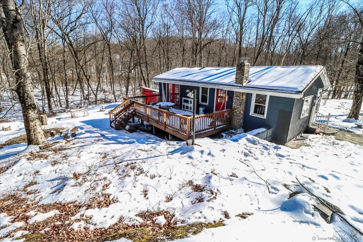a view of a house with a yard covered in snow
