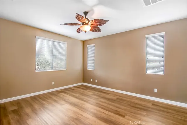 a view of a room with a window and ceiling fan