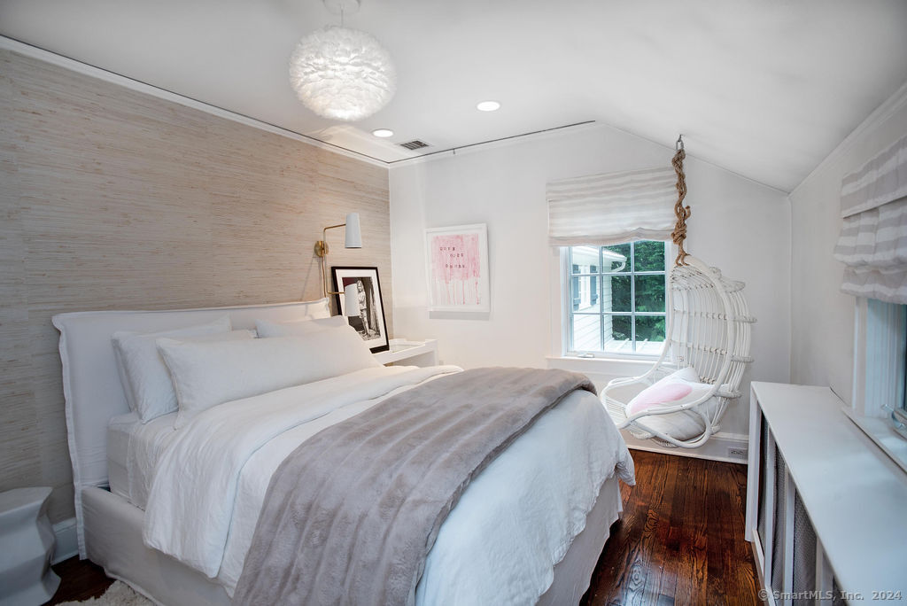 474 Brookside Road Norwalk, CT 06850 - Photo 21 of 40 a bedroom with a bed and a table with chair