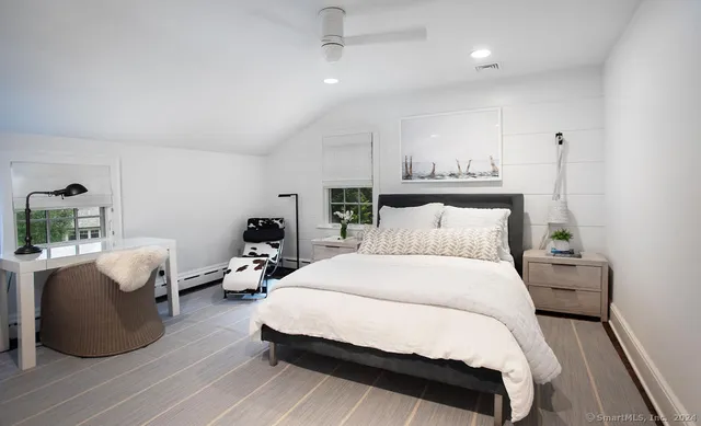 a bed room with bed and a chair