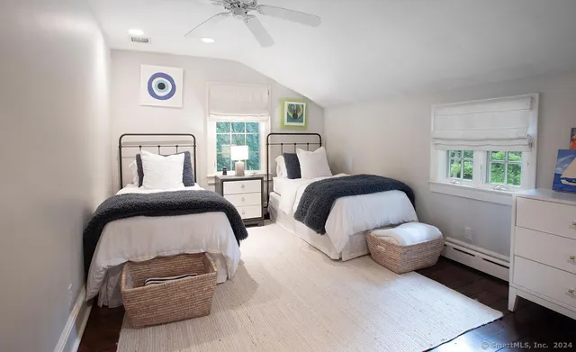 a bedroom with two beds and a window