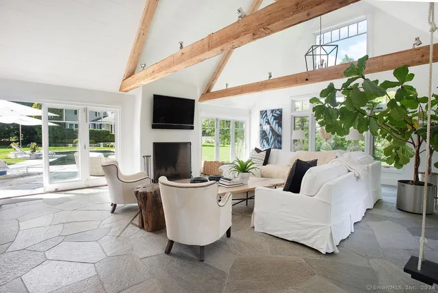 a living room with furniture fireplace and flat screen tv
