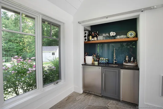 a kitchen with stainless steel appliances granite countertop a refrigerator and a window