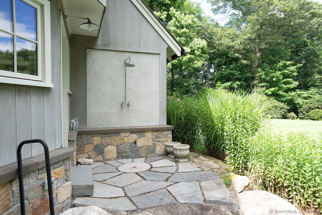 474 Brookside Road Norwalk, CT 06850 - Photo 35 of 40 a backyard of a house with large trees and plants