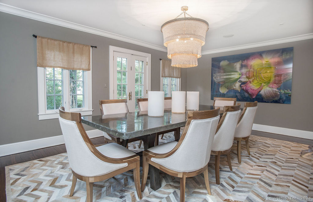 474 Brookside Road Norwalk, CT 06850 - Photo 6 of 40 a view of a dining room with furniture a chandelier and wooden floor