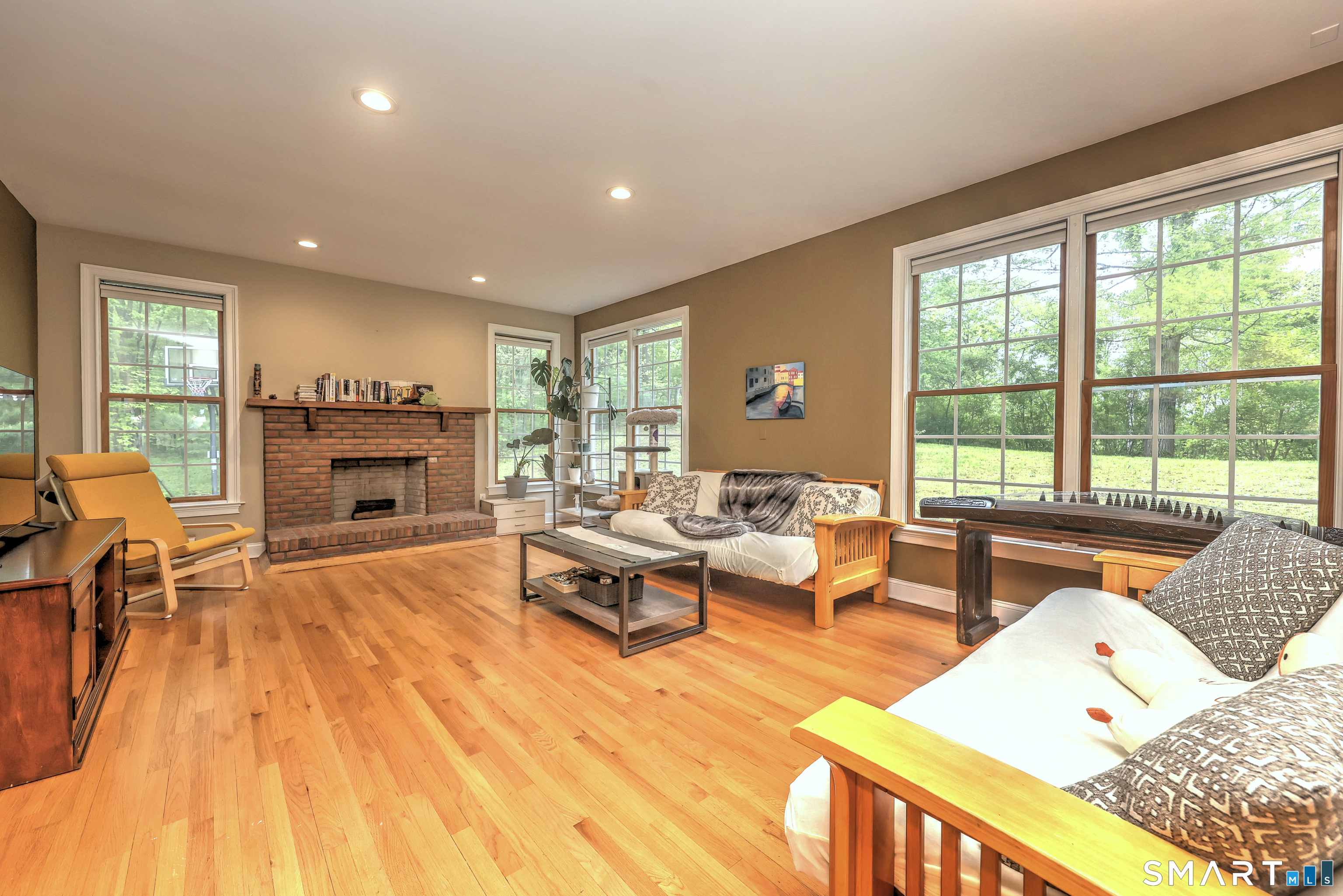 125 Peck Hill Road Woodbridge, CT 06525 - Photo 14 of 40 a living room with furniture and a fireplace