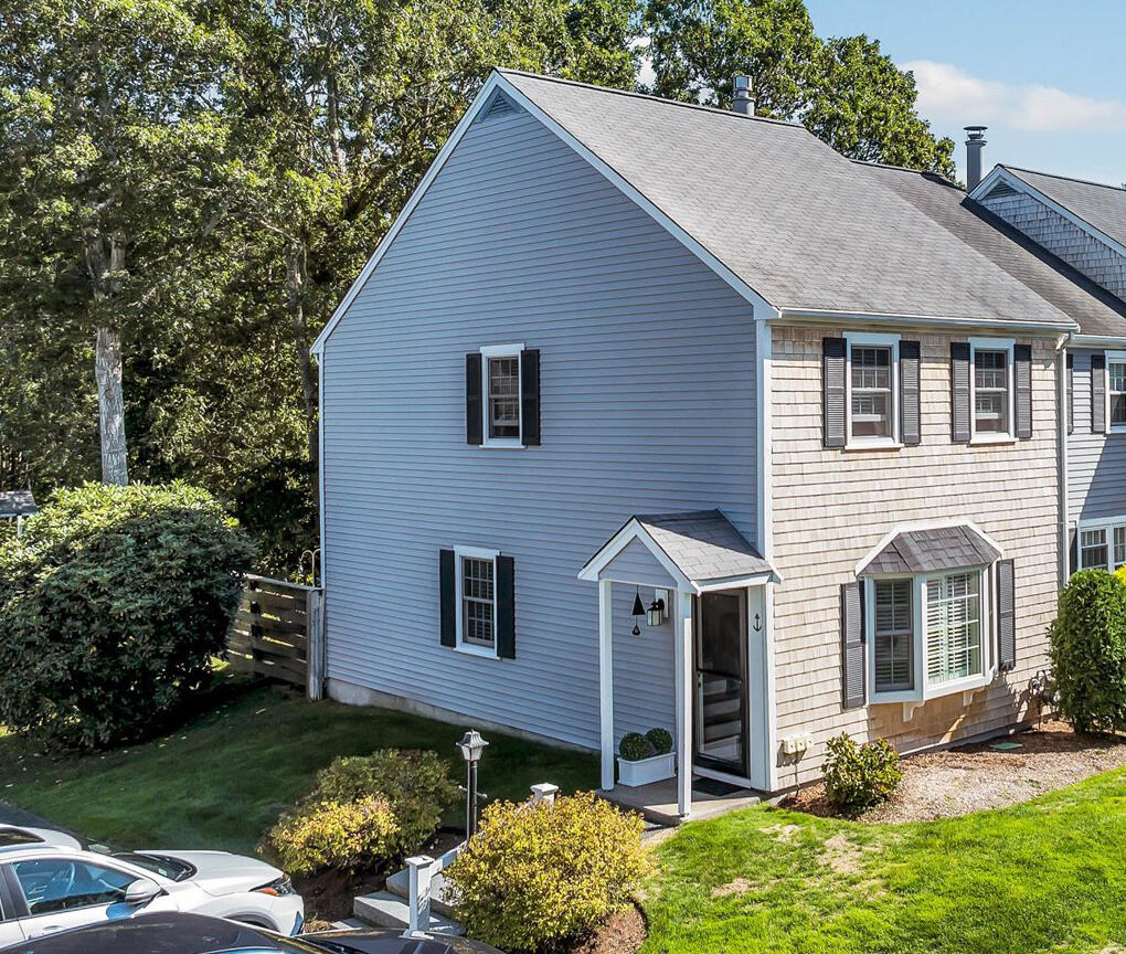 441 Buck Island Road, Unit B1 West Yarmouth, MA 02673 - Photo 1 of 31 a front view of a house with a yard